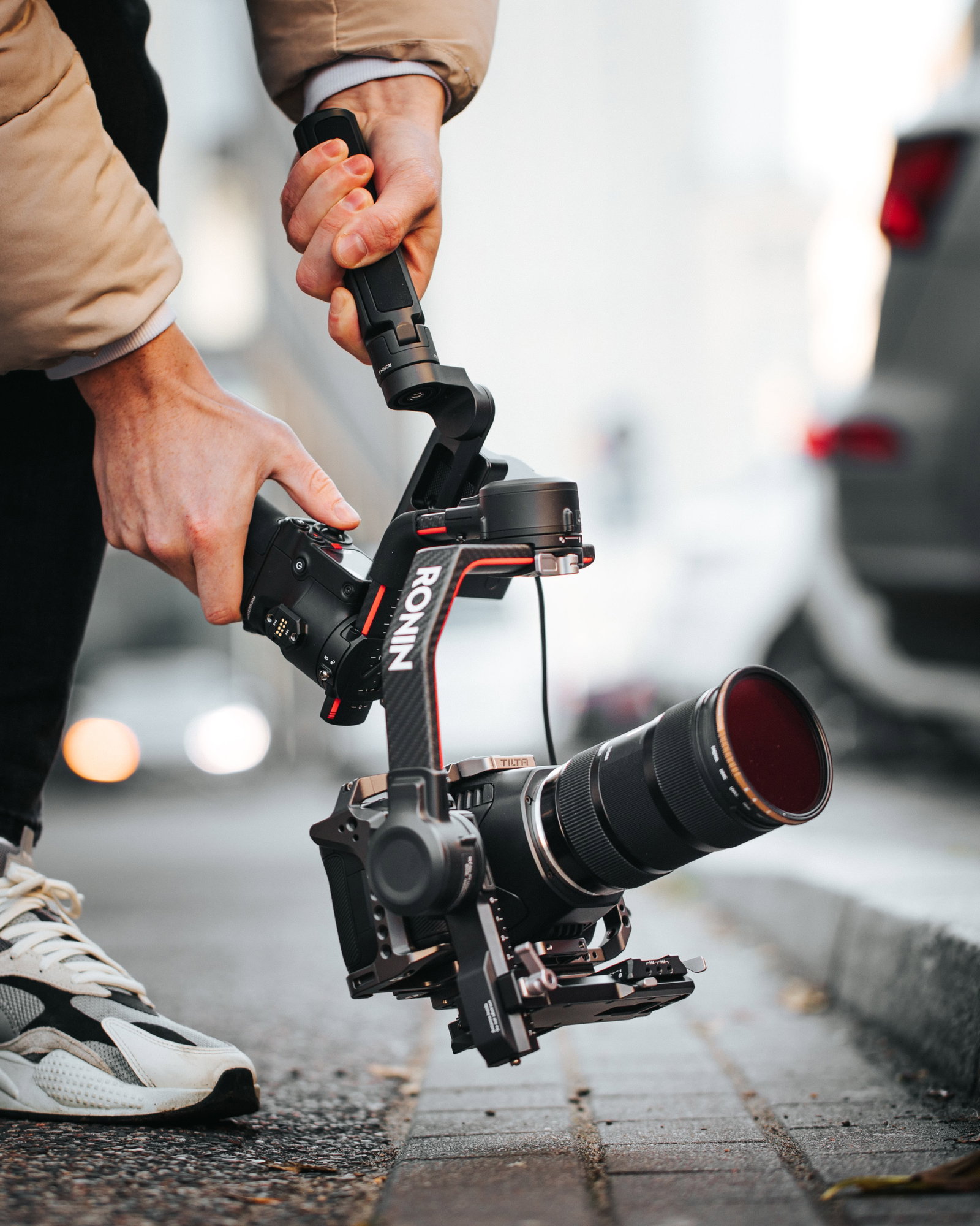 person holding black and red dslr camera