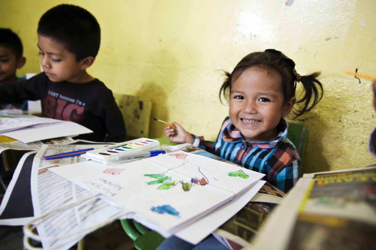 girl smiling beside printer paper