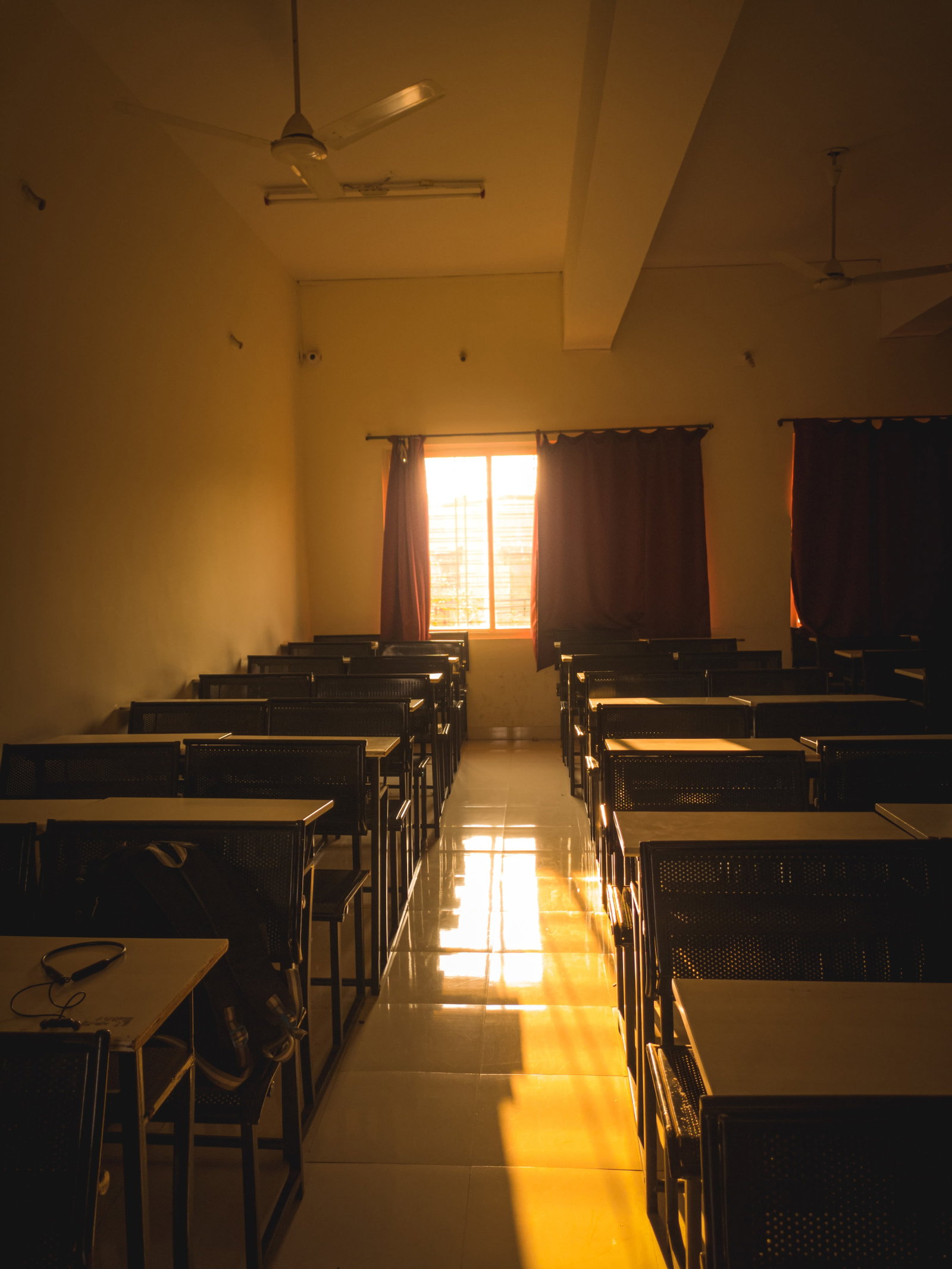 a room filled with tables and chairs next to a window