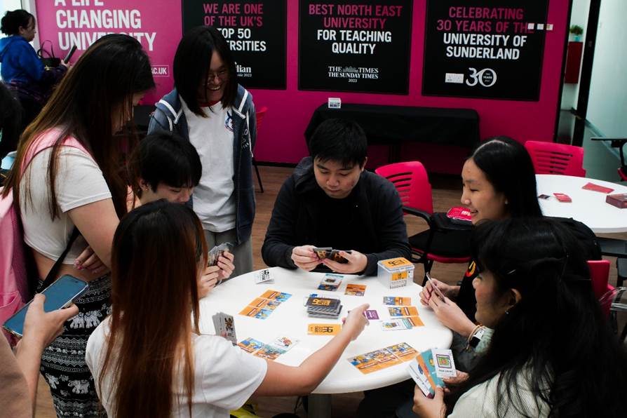 A group of people playing cards

AI-generated content may be incorrect.