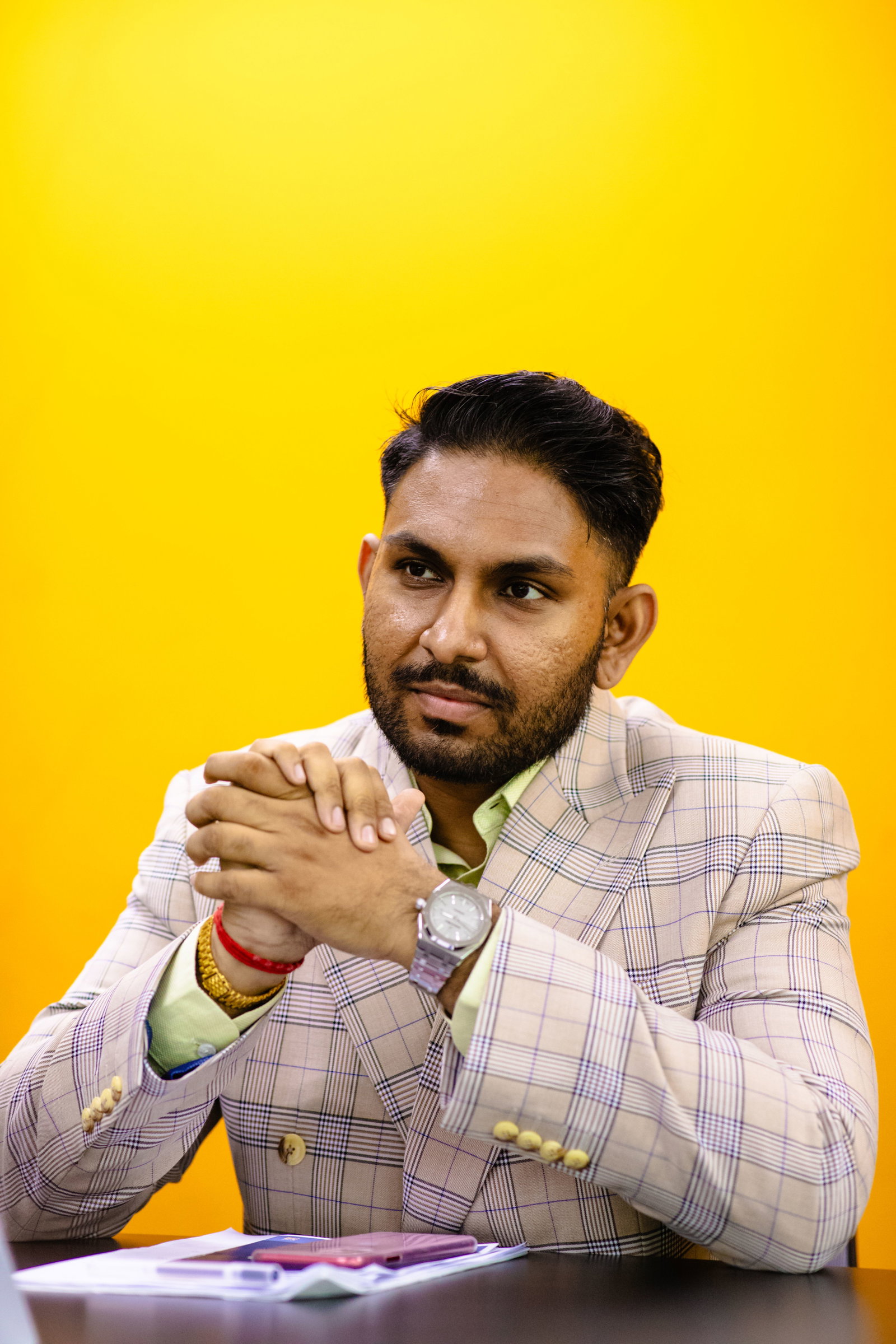 A person sitting with his hands together

AI-generated content may be incorrect.